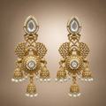 Antique gold peacock triple jhumka earrings with clear stones and white pearl-like drops