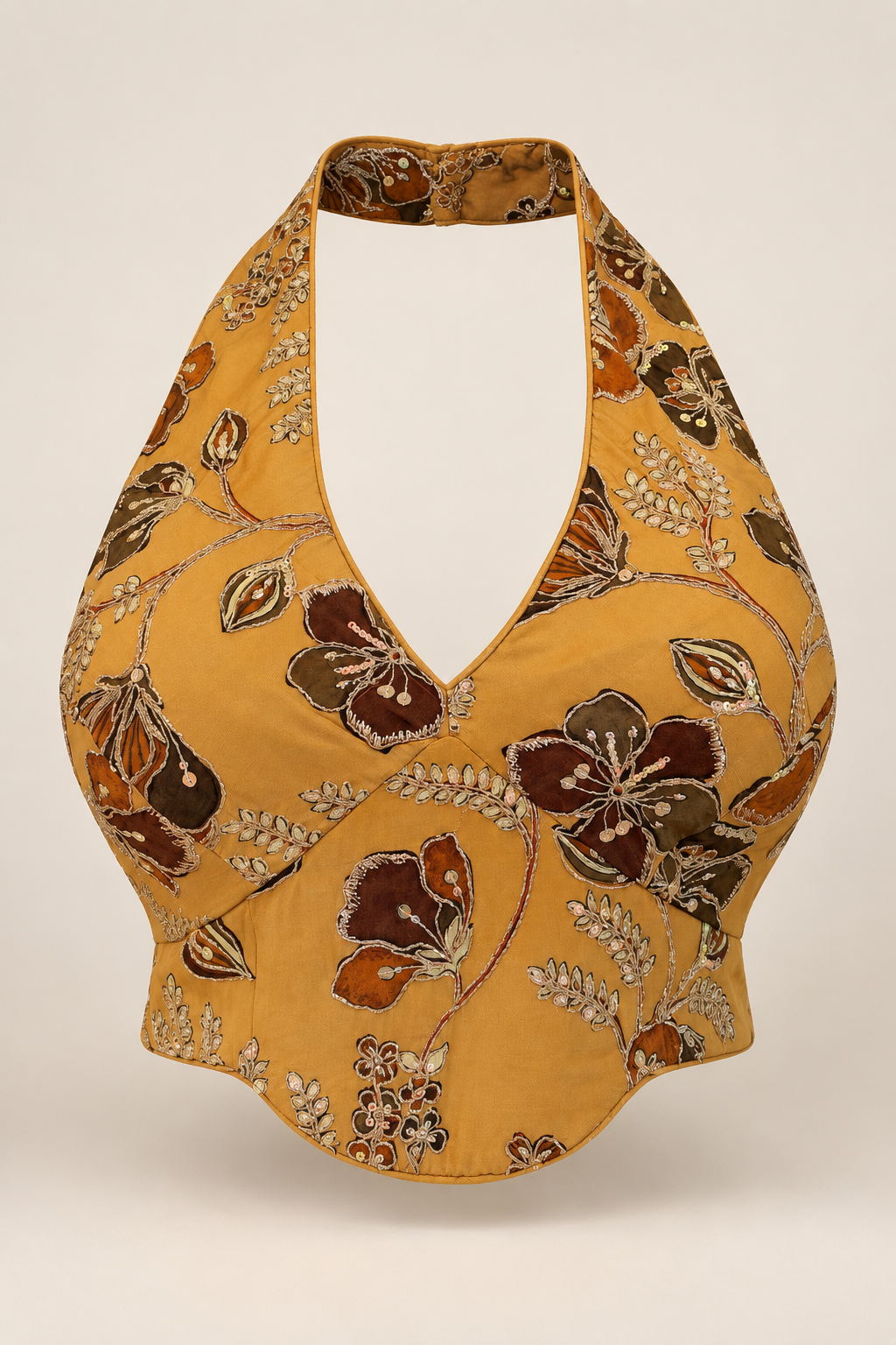 Mustard floral embroidered halter crop top with a deep neckline and curved hem, shown from the front.