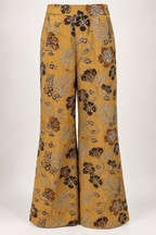 Mustard wide-leg palazzo trousers with brown and rust floral motifs and pale metallic embroidery.