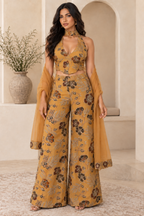 Straight-on full-length model view of the mustard halter top, palazzo trousers and scarf.