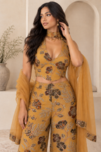 Closer model portrait showing the mustard floral embroidered top and scarf neck panel.