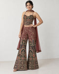 AI-styled model view: Woman in the embroidered outfit with one hand at her waist in the ivory room.