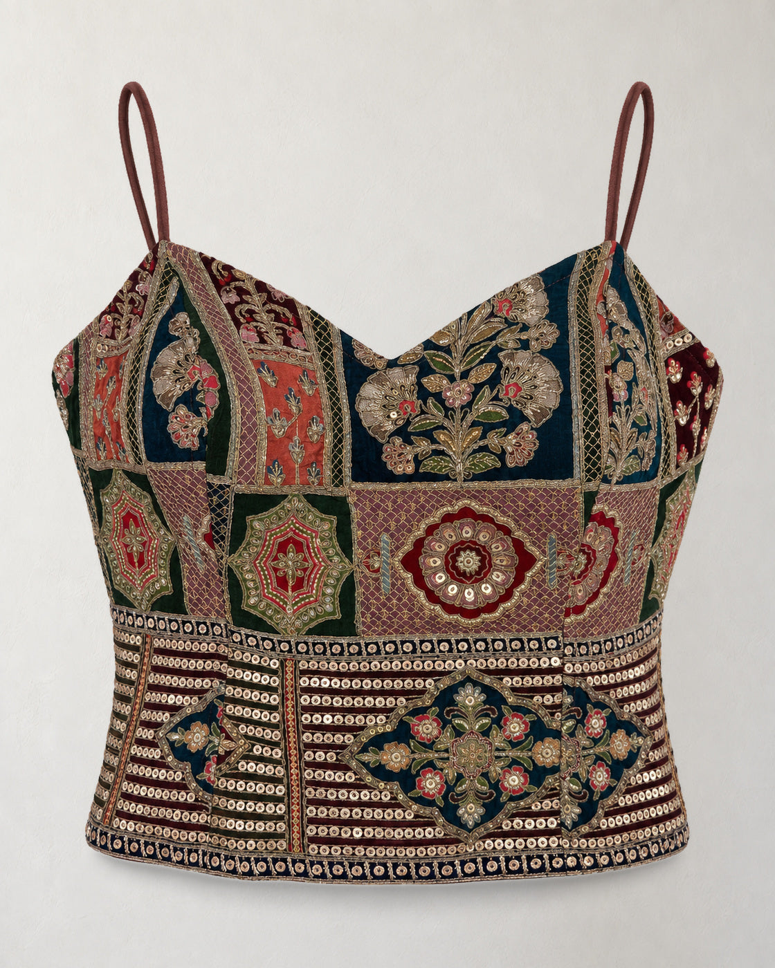 Digital garment presentation: Strappy embroidered cropped top shown alone against ivory, with multicoloured panels and a decorated hem.