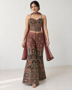 AI-styled model view: Woman taking a small step in the embroidered outfit, with the scarf falling beside her.