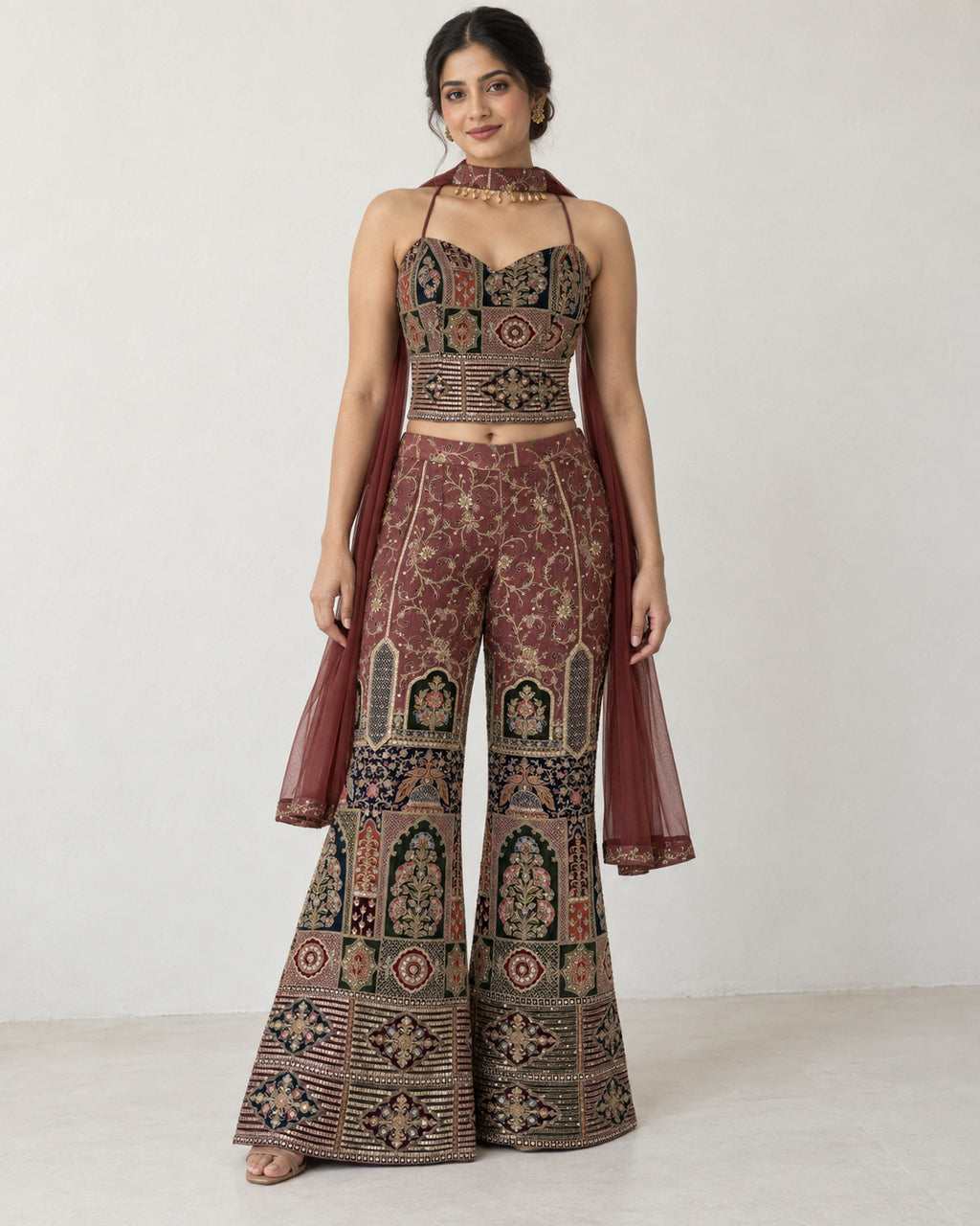 AI-styled model view: Woman standing front-facing in the embroidered three-piece outfit against an ivory wall.