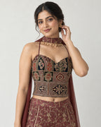 AI-styled model view: Closer portrait of the woman touching her earring, showing the embroidered top and scarf band.