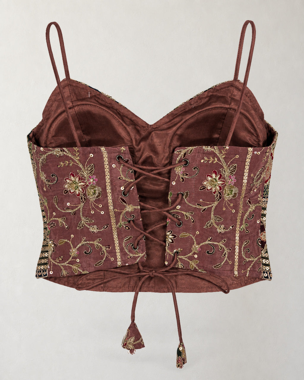 Digital garment presentation: Back of the cropped top with floral panels, eyelets, cross-lacing, hanging ties and visible inner lining.