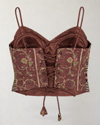 Digital garment presentation: Back of the cropped top with floral panels, eyelets, cross-lacing, hanging ties and visible inner lining.