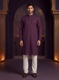 Merlot | Paisley Cotton Kurta Set | model wearing the complete kurta and ivory pajama in a Diwali courtyard