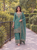 Model wearing the Jade Green Fendy embroidered three-piece palazzo set in a garden.