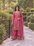 Model wearing the Rose Pink Fendy embroidered three-piece palazzo set in a garden.