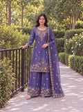 Model wearing the Violet Fendy embroidered three-piece palazzo set in a garden.